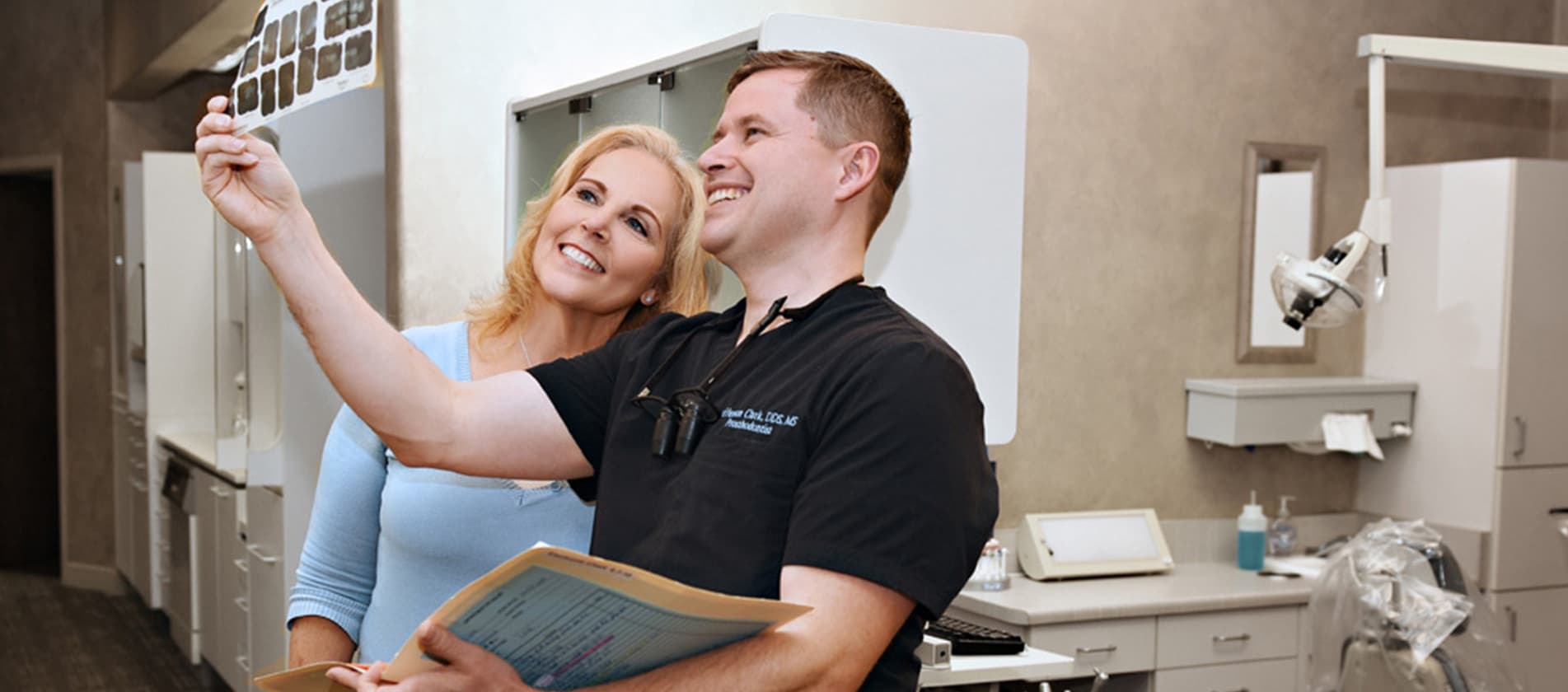 Dr. Jefferson Clark reviewing a patient's dental x-rays together in the treatment room