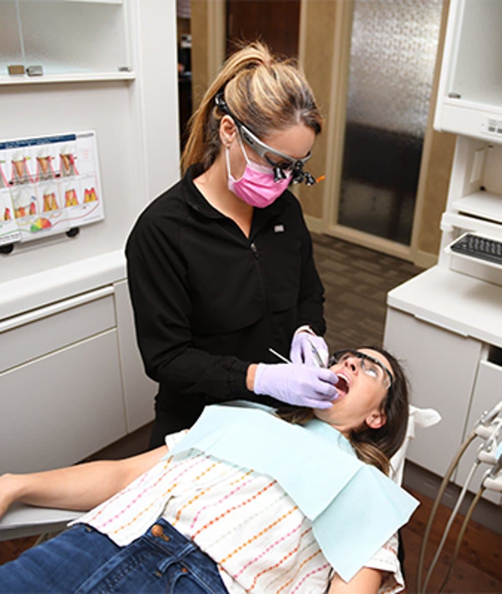 A member of Dr. Clark's clinical team providing careful, personalized restorative care